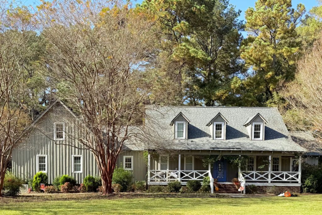 Ranch-style house surrounded by fall trees